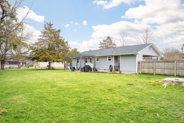 back of property featuring a yard