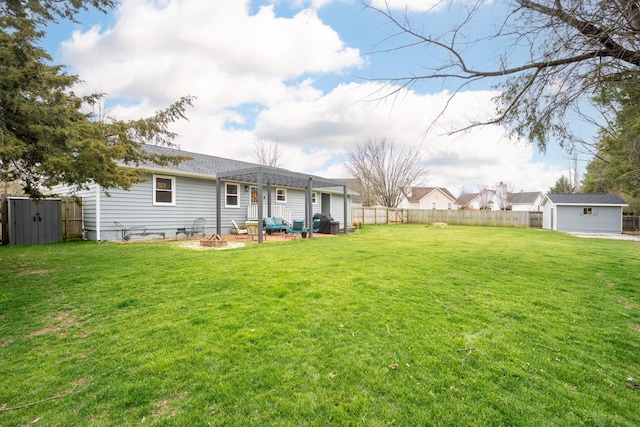 view of yard with a shed and a pergola