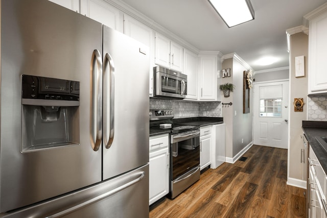 kitchen featuring stainless steel appliances, dark hardwood / wood-style floors, decorative backsplash, and white cabinets