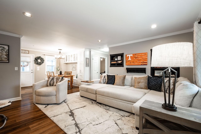 living room with hardwood / wood-style flooring and ornamental molding