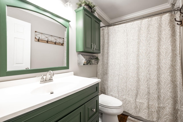 bathroom with vanity, crown molding, and toilet