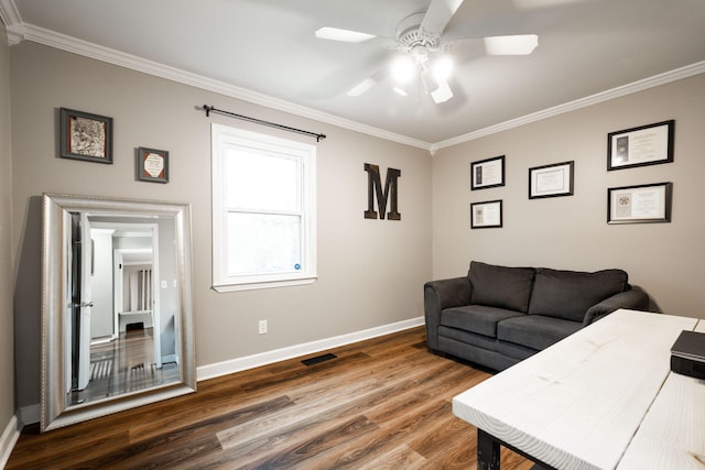 living room with crown molding, wood-type flooring, and ceiling fan