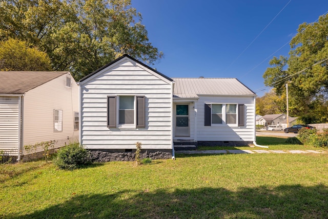 rear view of property with a lawn