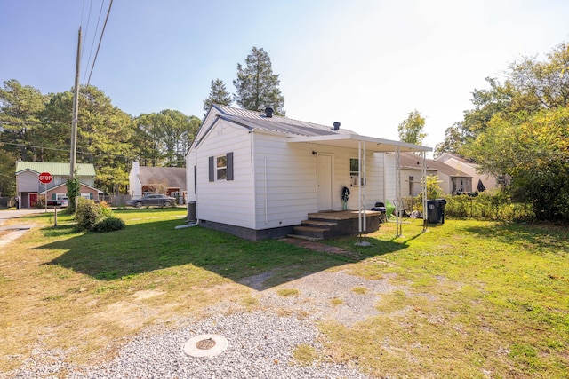 back of property featuring a lawn