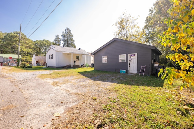 rear view of house featuring a yard