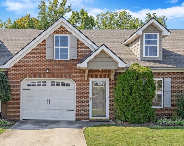 view of front of property with a garage and a front yard