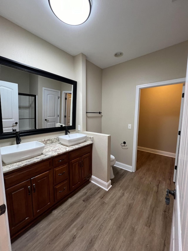 bathroom with vanity, hardwood / wood-style floors, and toilet