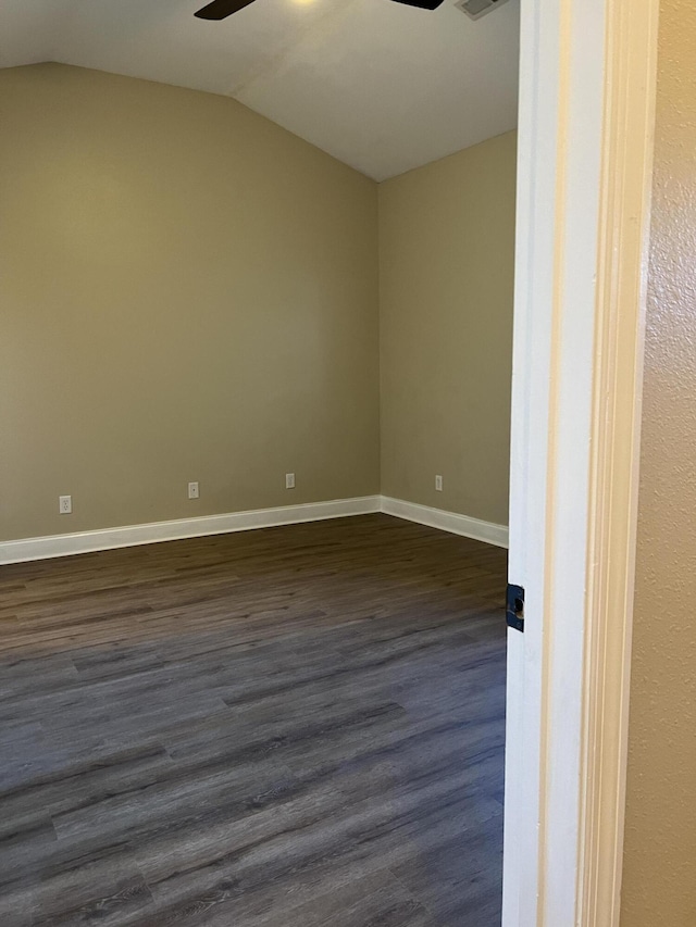 unfurnished room with dark hardwood / wood-style flooring, vaulted ceiling, and ceiling fan