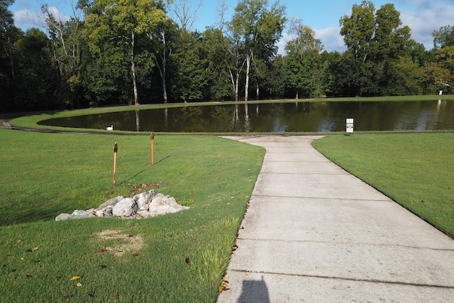 view of home's community with a yard and a water view