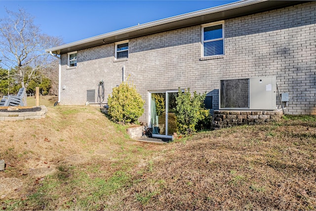 rear view of property featuring a yard