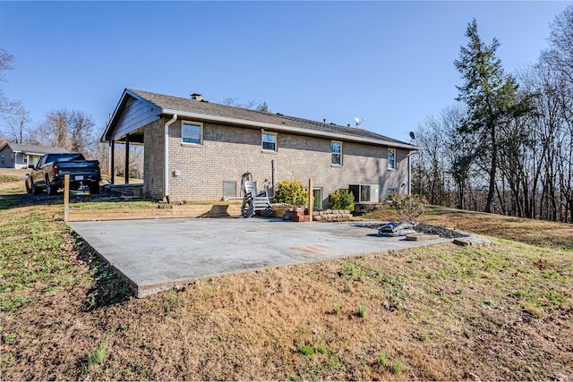 rear view of house featuring a yard and a patio