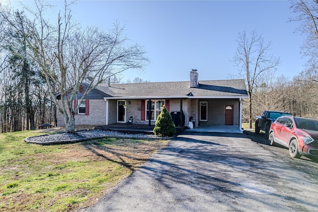 single story home featuring covered porch and a front yard