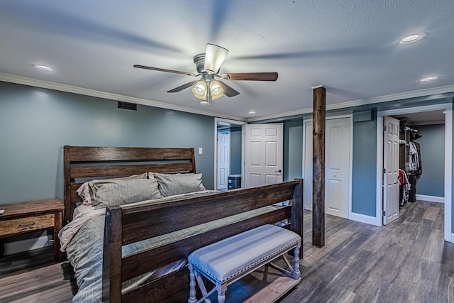 bedroom featuring dark wood-type flooring, ceiling fan, and crown molding