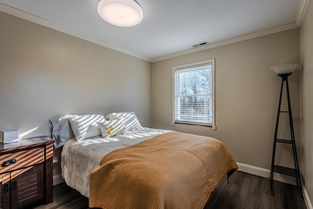 bedroom featuring ornamental molding and dark hardwood / wood-style floors