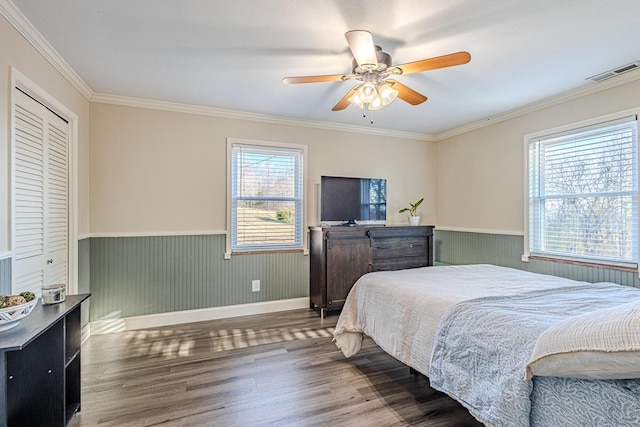 bedroom featuring ornamental molding, dark wood-type flooring, and ceiling fan