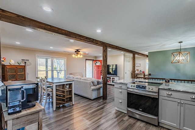 kitchen with pendant lighting, electric range, dark hardwood / wood-style floors, light stone countertops, and beamed ceiling