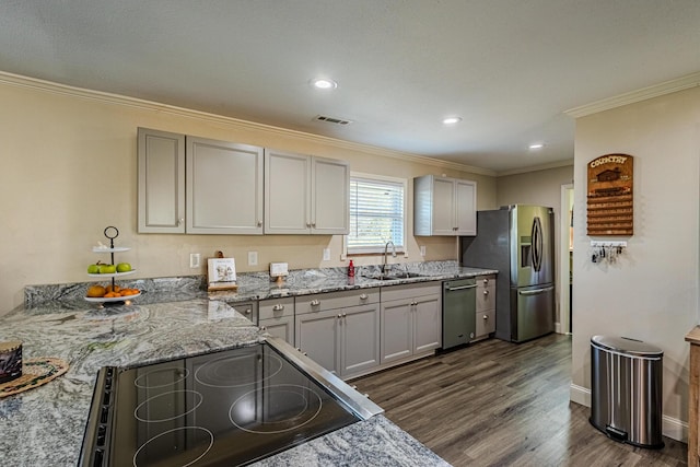 kitchen featuring sink, appliances with stainless steel finishes, ornamental molding, light stone countertops, and dark hardwood / wood-style flooring