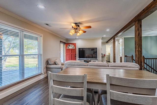 dining area featuring dark wood-type flooring, ceiling fan, and ornamental molding