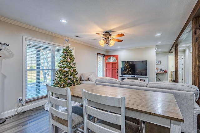 dining area featuring hardwood / wood-style flooring, ornamental molding, and ceiling fan