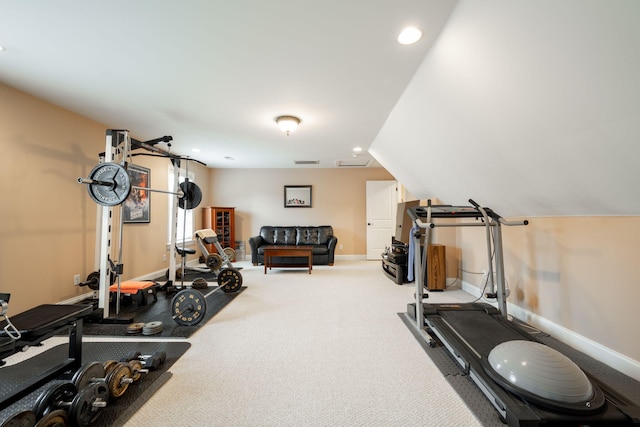 workout room featuring vaulted ceiling and carpet floors