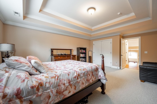 carpeted bedroom featuring crown molding and a raised ceiling