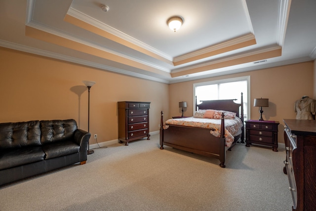 bedroom with crown molding, a tray ceiling, and light colored carpet