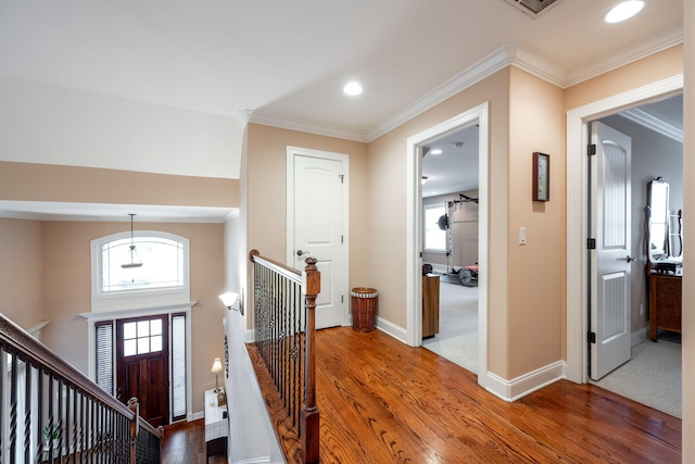 foyer with ornamental molding, plenty of natural light, and dark hardwood / wood-style floors