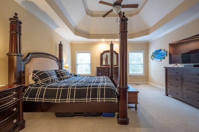 bedroom featuring crown molding, light colored carpet, and a raised ceiling