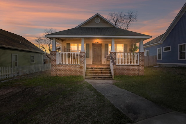 bungalow featuring a yard and covered porch