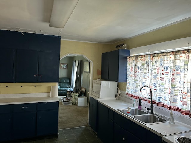 kitchen featuring sink and dark colored carpet