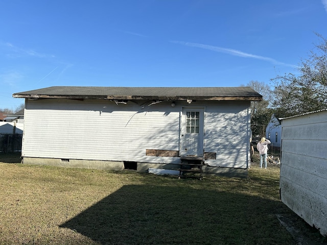 rear view of house with a lawn