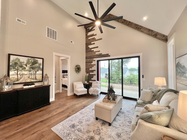 living area featuring a ceiling fan, wood finished floors, high vaulted ceiling, baseboards, and beam ceiling