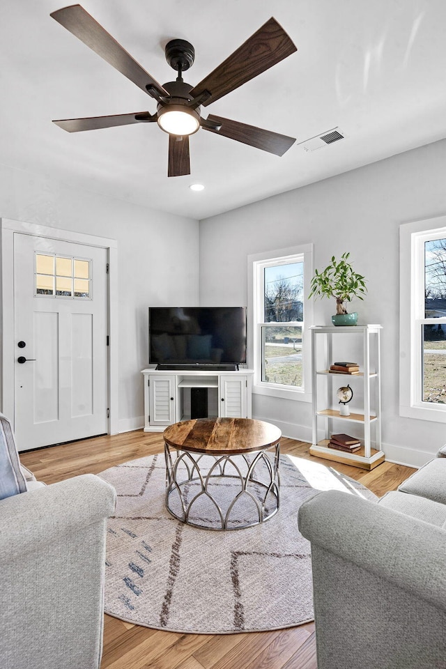 living room featuring hardwood / wood-style flooring and ceiling fan