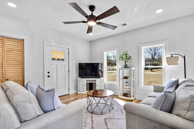 living room with ceiling fan and light wood-type flooring