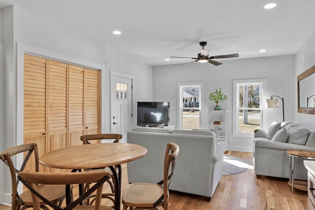 dining space featuring ceiling fan and light wood-type flooring