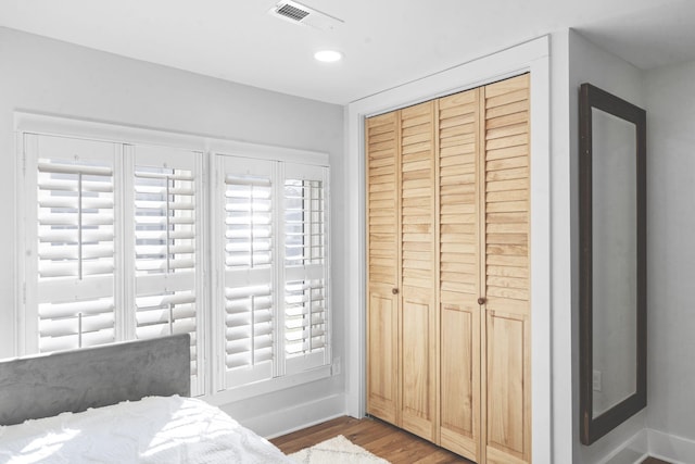 bedroom featuring hardwood / wood-style floors and a closet