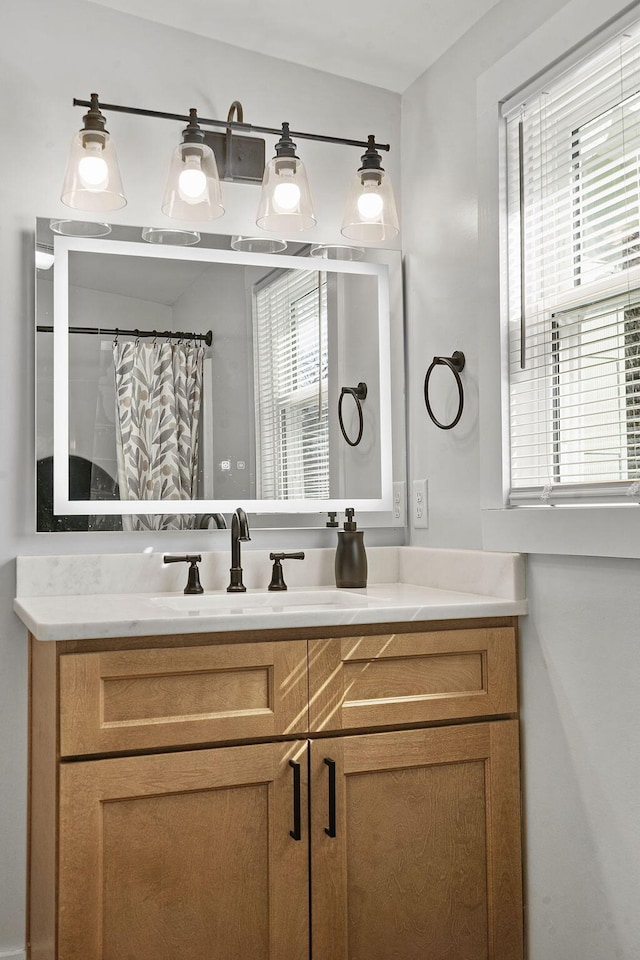 bathroom with vanity and curtained shower