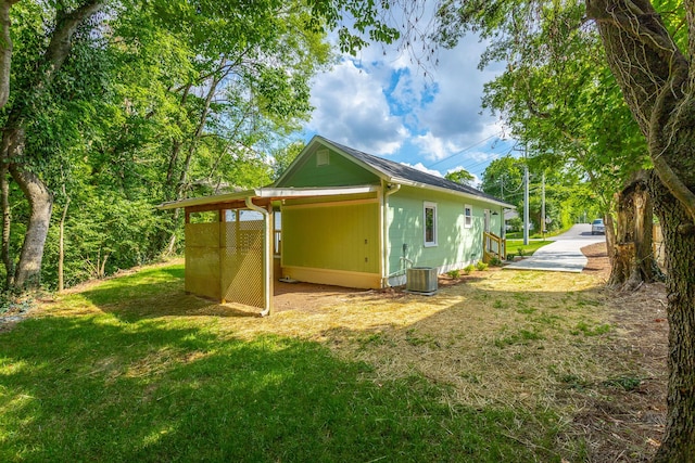 rear view of house featuring a carport and a lawn