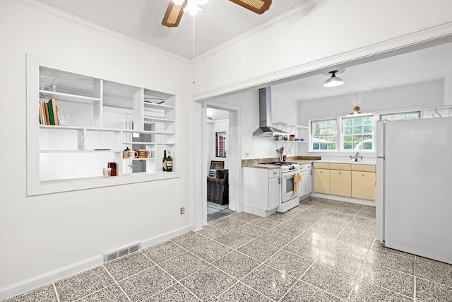 kitchen featuring sink, ceiling fan, crown molding, white appliances, and wall chimney exhaust hood