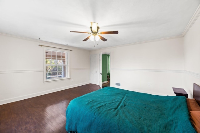 unfurnished bedroom with crown molding, dark hardwood / wood-style floors, and ceiling fan