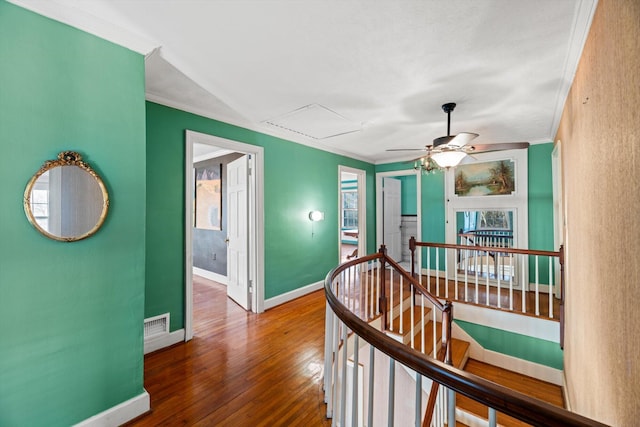 corridor with crown molding and wood-type flooring