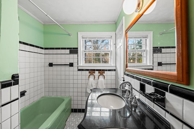 bathroom featuring vanity, tile walls, tile patterned floors, and washtub / shower combination