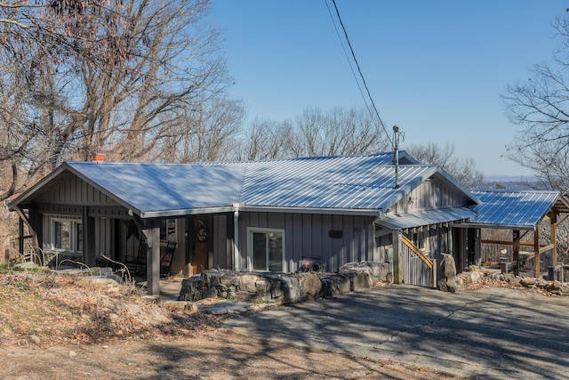 rustic home featuring board and batten siding and metal roof