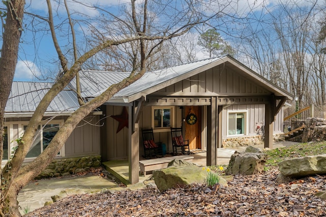 view of front facade with board and batten siding and metal roof