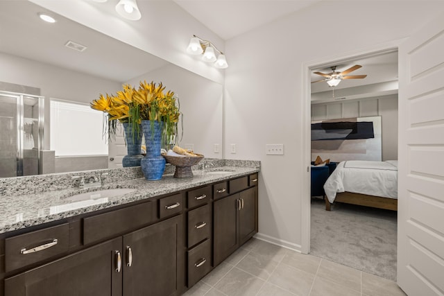 bathroom featuring walk in shower, tile patterned floors, vanity, and ceiling fan