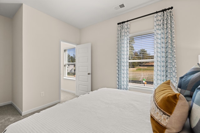 bedroom featuring light carpet