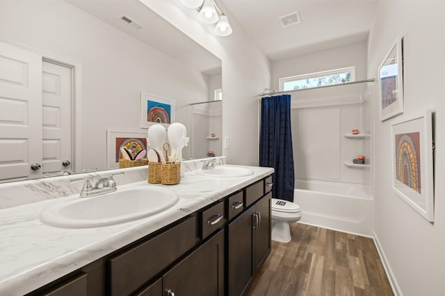 full bathroom with toilet, wood-type flooring, shower / bathtub combination with curtain, and vanity