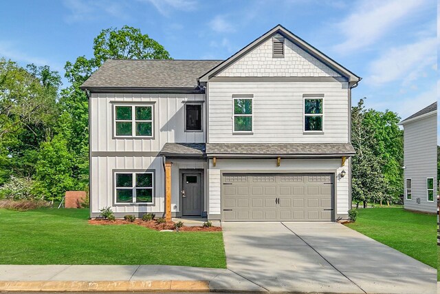 view of front of house featuring board and batten siding, a shingled roof, concrete driveway, and a front yard