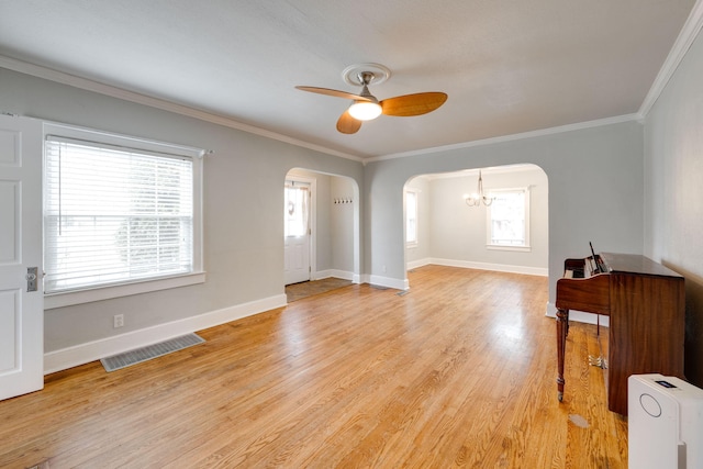 interior space with ceiling fan, light hardwood / wood-style floors, and crown molding