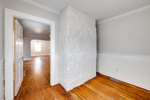 spare room featuring crown molding and wood-type flooring